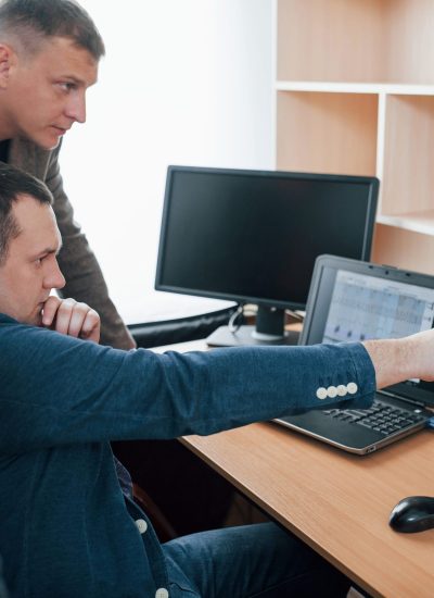 Three people. Polygraph examiners works in the office with his lie detector's equipment